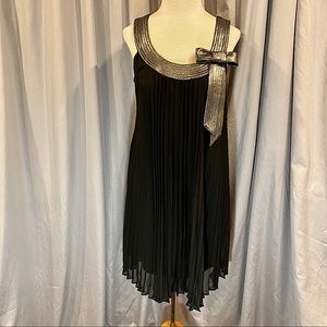 Cocktail dress with metallic trim.  Pleads allow room and flow.